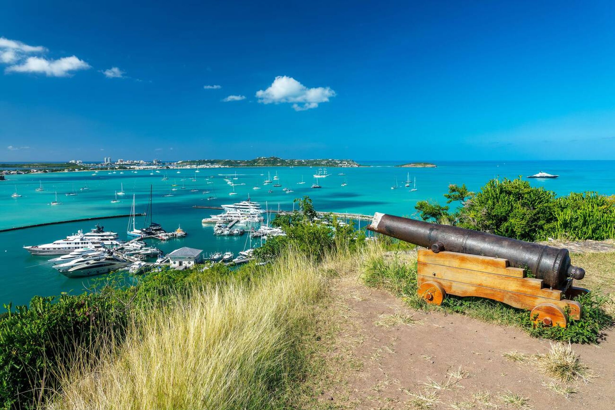 Aerial view of turquoise water and luxury yachts near Marigot Bay, St. Maarten.